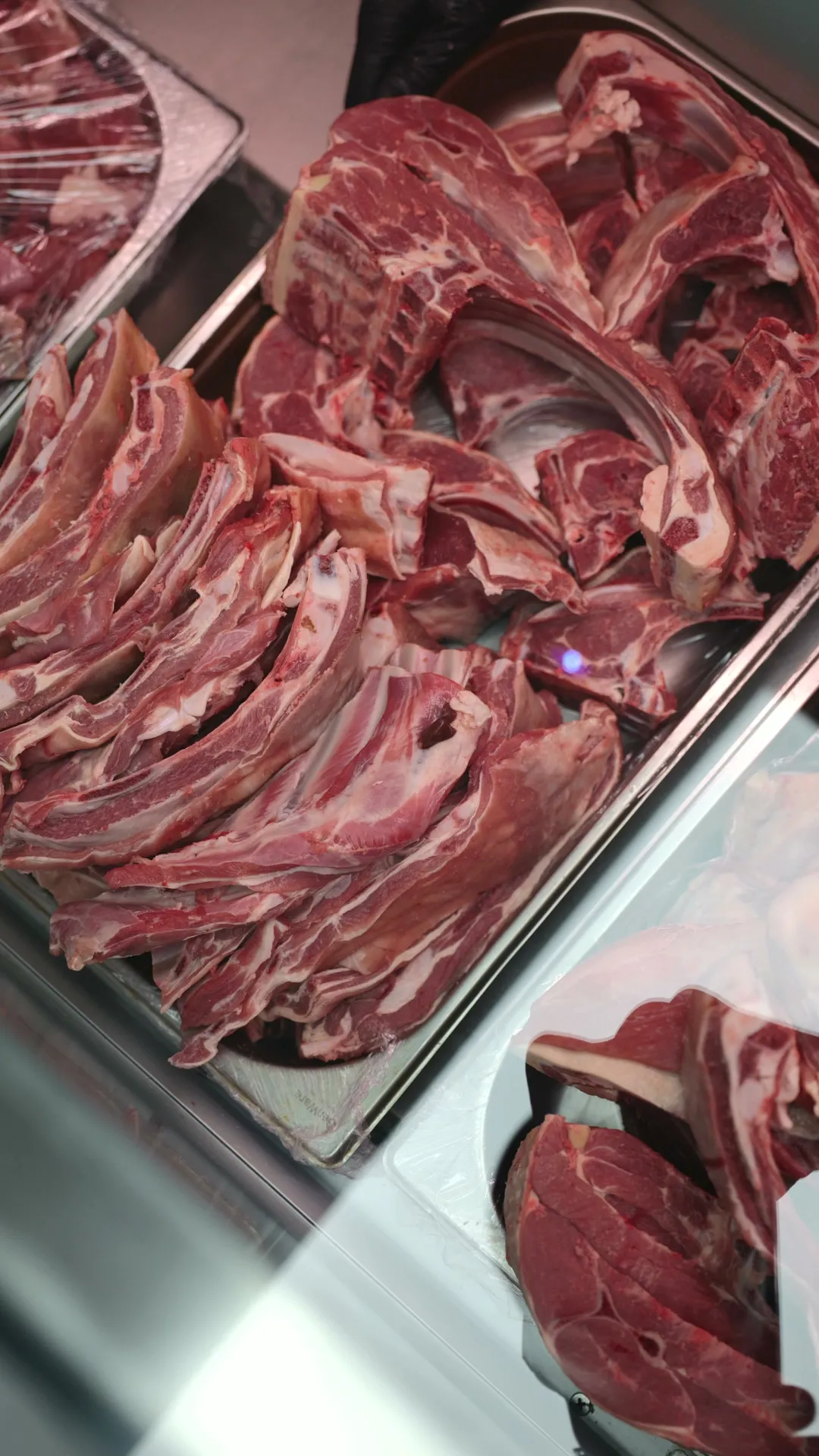 Fresh lamb chops laid out in the halal butcher counter